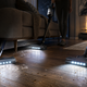 Best cordless vacuums with LED lights revealing hidden dust, pet hair, and debris on dark hardwood floors.