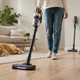Best quiet cordless vacuums in 2026 shown cleaning near a sleeping dog in a peaceful modern living room.